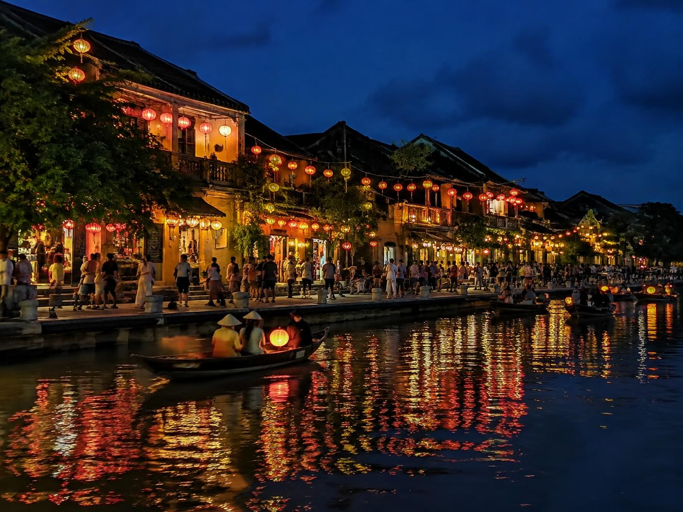 Lanterns glowing along the river in Hoi An at night